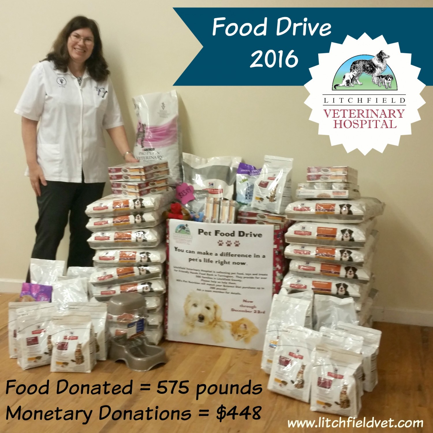 Veterinarian posing in front of piled pet food for a food drive